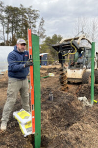 green team builder staff building a fence