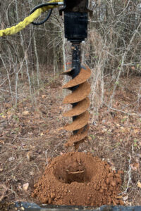 fence post digging auger skid steerer