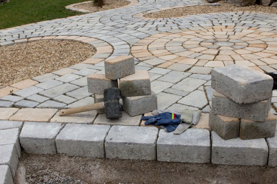 Concrete pad and stone walkway installed by staff at green team builders