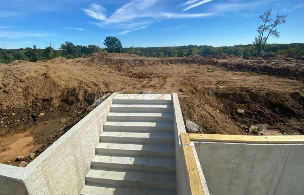 concrete pad and retaining wall construction for steps